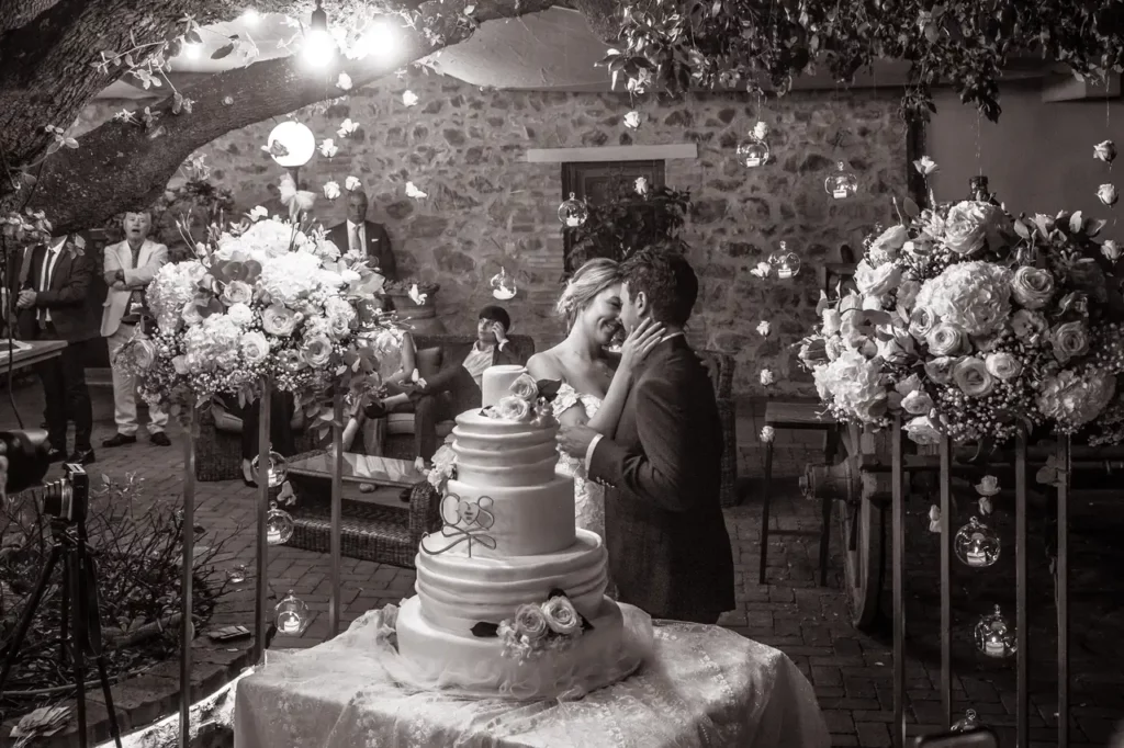 The bride and groom during the cutting of the wedding cake